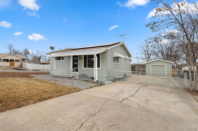 view of front of house featuring an outbuilding, a porch, and a garage