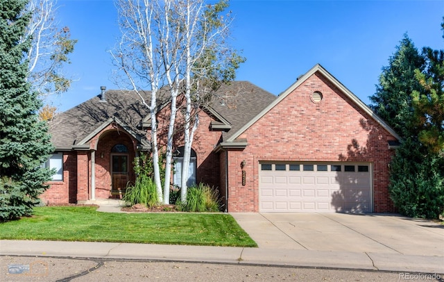 2425 Waneka Lake Trl, Lafayette, CO 80026 - traditional-style house with a garage, concrete driveway, brick siding, a front lawn, and roof with shingles
