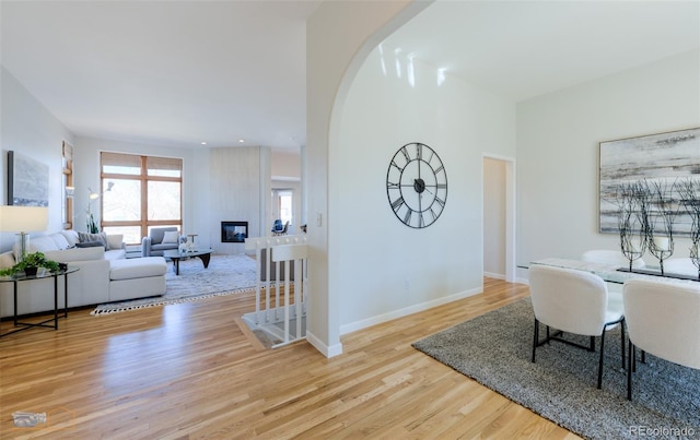 2425 Waneka Lake Trl, Lafayette, CO 80026 - dining room featuring wood finished floors, baseboards, a fireplace, and recessed lighting