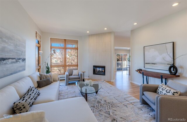 2425 Waneka Lake Trl, Lafayette, CO 80026 - living room with wood finished floors, recessed lighting, a tile fireplace, and baseboards