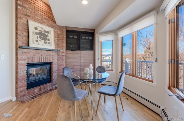 2425 Waneka Lake Trl, Lafayette, CO 80026 - dining area featuring wood finished floors, a fireplace, and baseboards