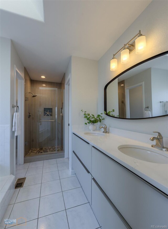 2425 Waneka Lake Trl, Lafayette, CO 80026 - full bath featuring double vanity, a shower stall, and tile patterned floors