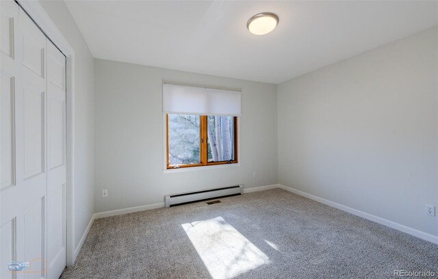 2425 Waneka Lake Trl, Lafayette, CO 80026 - unfurnished bedroom featuring a baseboard radiator, carpet floors, baseboards, and a closet