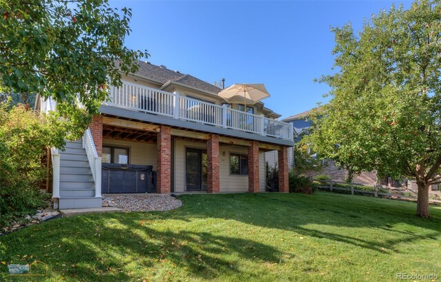 2425 Waneka Lake Trl, Lafayette, CO 80026 - rear view of house featuring a hot tub, stairs, a deck, and a yard