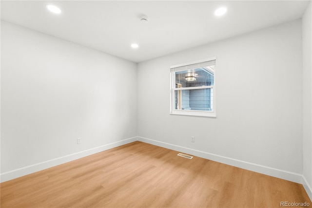 spare room featuring wood-type flooring