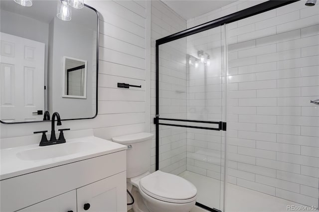 bathroom with vanity, an enclosed shower, and toilet