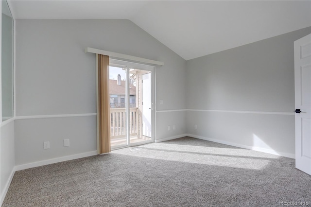 empty room with vaulted ceiling and carpet floors