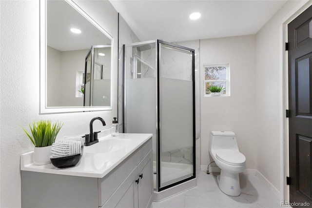 bathroom featuring vanity, toilet, and a shower with door