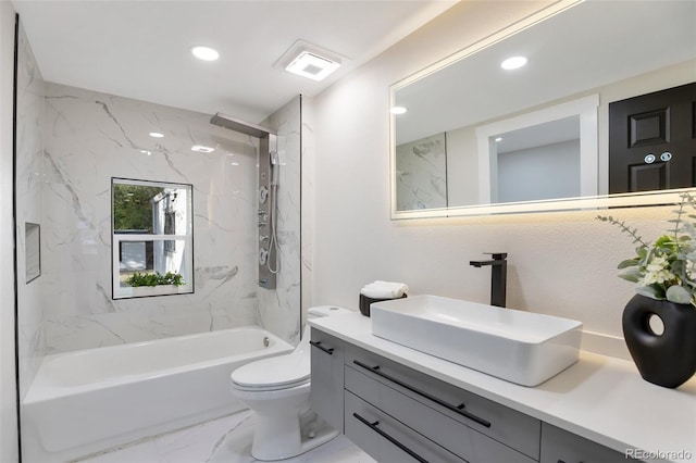 full bathroom with vanity, toilet, and tiled shower / bath