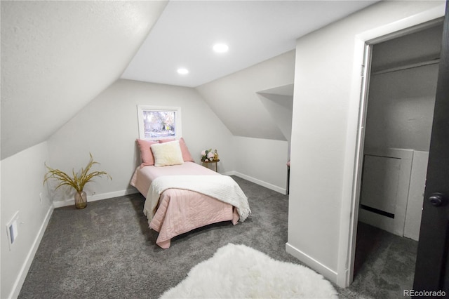 bedroom featuring dark carpet and vaulted ceiling