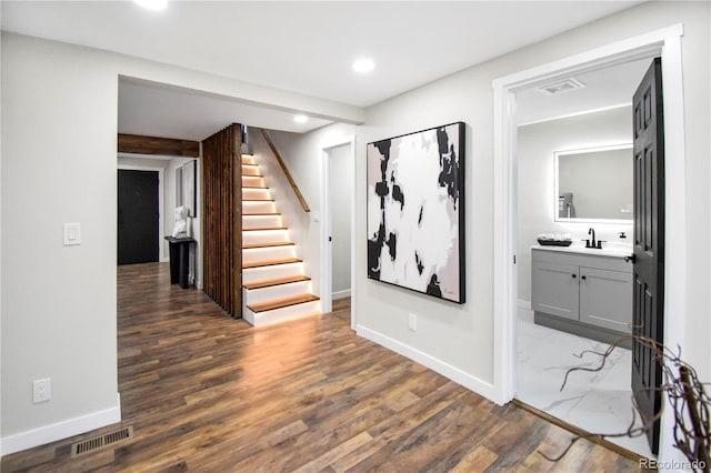 hall featuring dark hardwood / wood-style flooring and sink