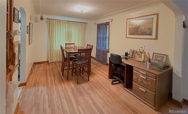 200 W 5th St, Julesburg, CO 80737 - dining area featuring arched walkways, light wood-style floors, a desk, and baseboards