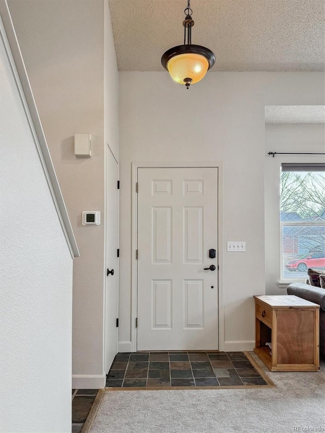 foyer entrance featuring a textured ceiling