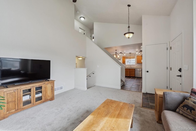 living room featuring sink, light colored carpet, and high vaulted ceiling