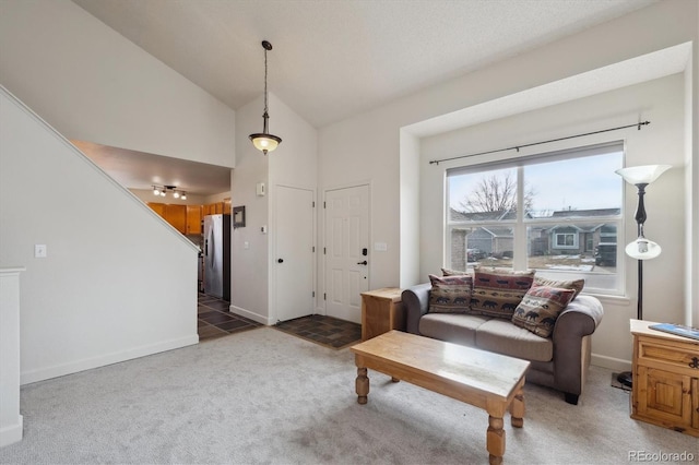 living room with lofted ceiling and dark colored carpet