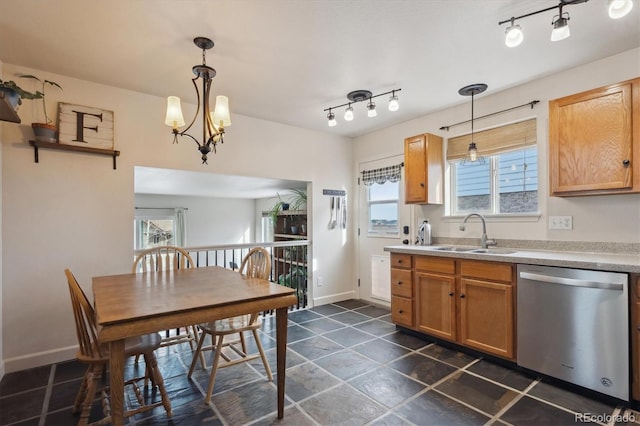 kitchen featuring decorative light fixtures, sink, dishwasher, and an inviting chandelier