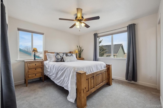 bedroom with ceiling fan and light colored carpet