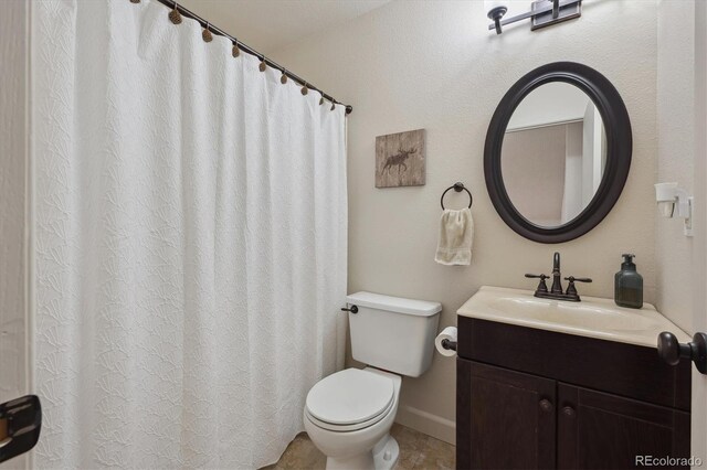 bathroom with toilet and vanity