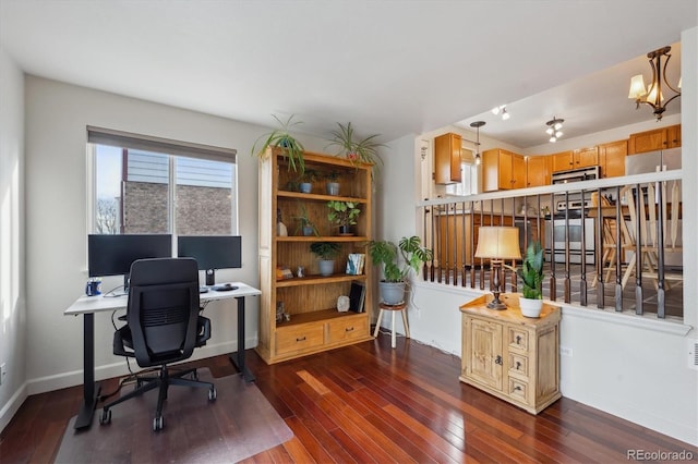 office space with a chandelier and dark wood-type flooring