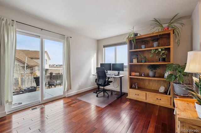 home office with dark hardwood / wood-style floors