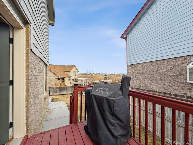 wooden terrace featuring area for grilling