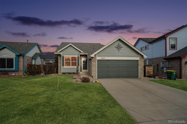 view of front of house featuring a garage and a lawn