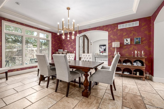 648 Ruby Trust Dr, Castle Rock, CO 80108 - dining area with wallpapered walls, a raised ceiling, arched walkways, baseboards, and a chandelier