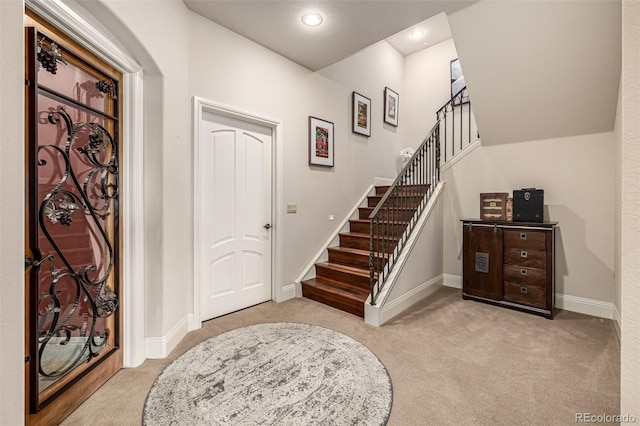 648 Ruby Trust Dr, Castle Rock, CO 80108 - foyer entrance featuring light colored carpet, baseboards, stairs, and recessed lighting