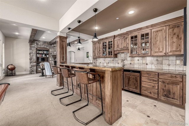 648 Ruby Trust Dr, Castle Rock, CO 80108 - kitchen with a breakfast bar, backsplash, glass insert cabinets, recessed lighting, and hanging light fixtures