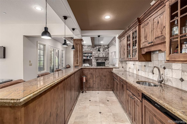648 Ruby Trust Dr, Castle Rock, CO 80108 - kitchen with a sink, open floor plan, light stone countertops, a stone fireplace, and decorative backsplash