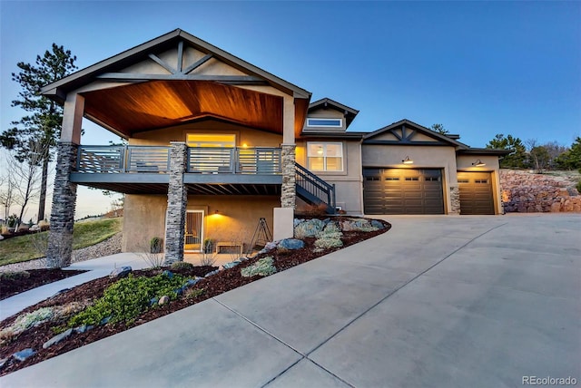 20243 High Pines Dr, Monument, CO 80132 - view of front of house with stucco siding, stairway, stone siding, and driveway