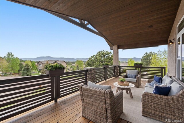 20243 High Pines Dr, Monument, CO 80132 - wooden deck with an outdoor hangout area and a mountain view