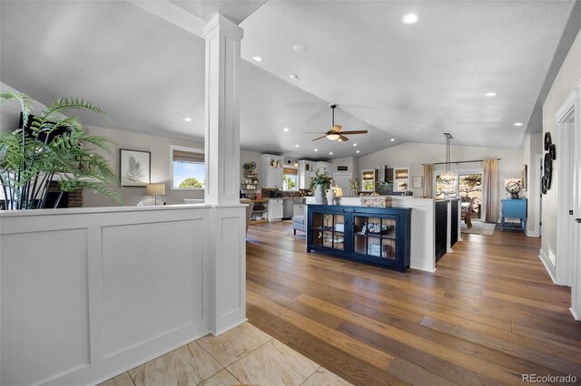 20243 High Pines Dr, Monument, CO 80132 - living room featuring lofted ceiling, ceiling fan, recessed lighting, wood finished floors, and decorative columns