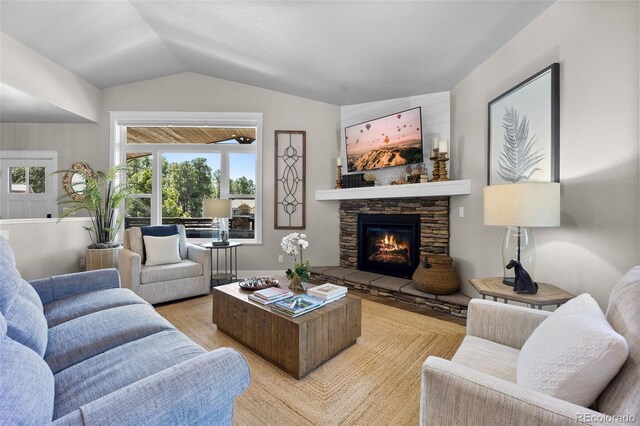 20243 High Pines Dr, Monument, CO 80132 - living area featuring a fireplace, vaulted ceiling, and light wood-style floors