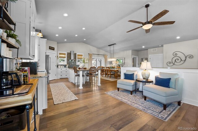 20243 High Pines Dr, Monument, CO 80132 - living area with ceiling fan, lofted ceiling, wood finished floors, and recessed lighting