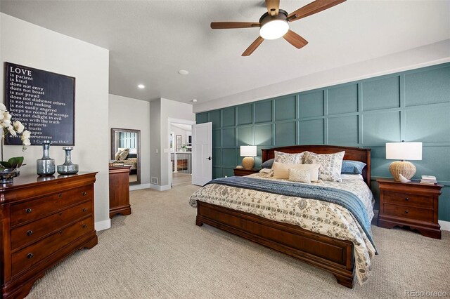 20243 High Pines Dr, Monument, CO 80132 - bedroom with light carpet, a decorative wall, ceiling fan, recessed lighting, and baseboards