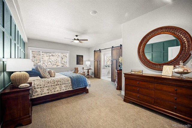 20243 High Pines Dr, Monument, CO 80132 - bedroom featuring a barn door, carpet, multiple windows, and a ceiling fan