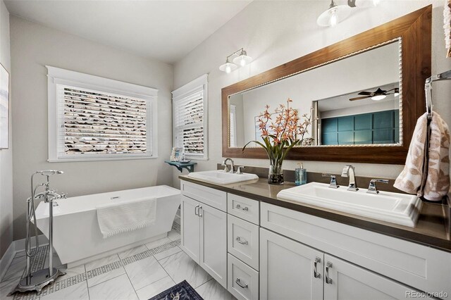 20243 High Pines Dr, Monument, CO 80132 - full bath featuring marble finish flooring, double vanity, a freestanding bath, and a ceiling fan