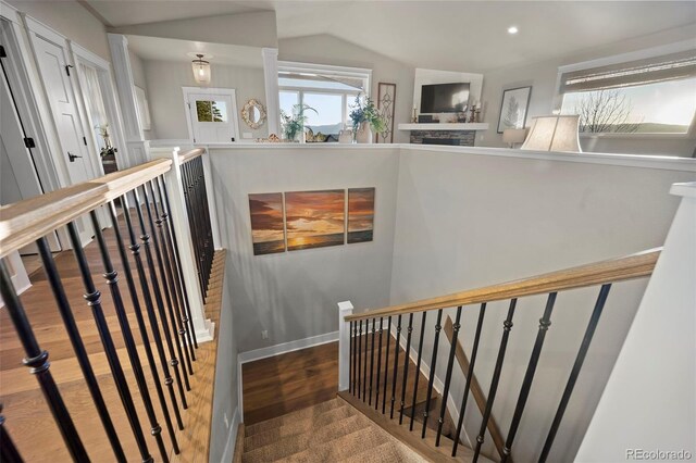 20243 High Pines Dr, Monument, CO 80132 - stairway featuring wood finished floors, vaulted ceiling, and recessed lighting
