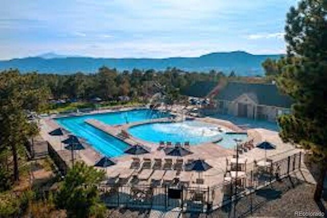 20243 High Pines Dr, Monument, CO 80132 - community pool with a mountain view and a patio