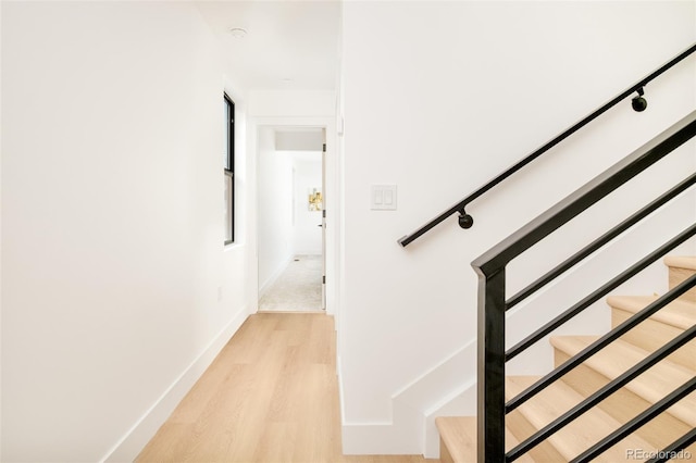 stairs featuring hardwood / wood-style flooring