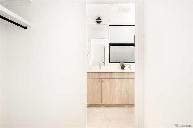 bathroom with tile patterned floors and vanity