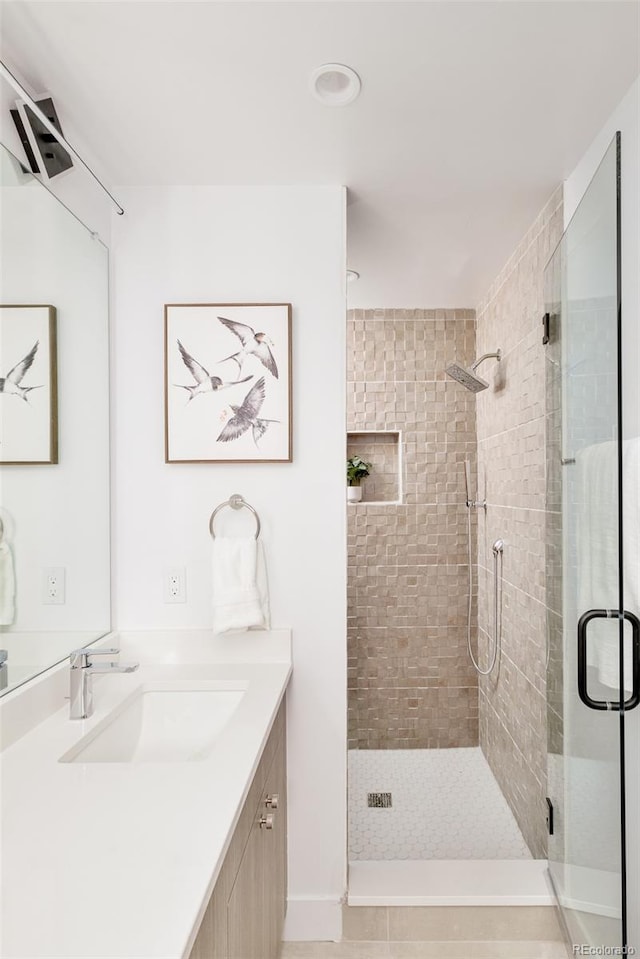 bathroom featuring vanity and an enclosed shower