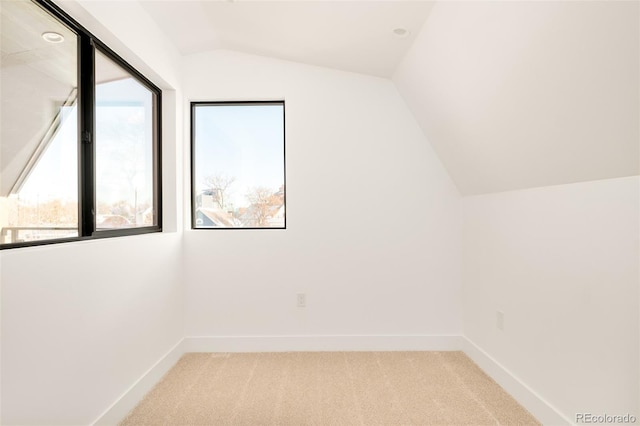 additional living space with lofted ceiling and light carpet