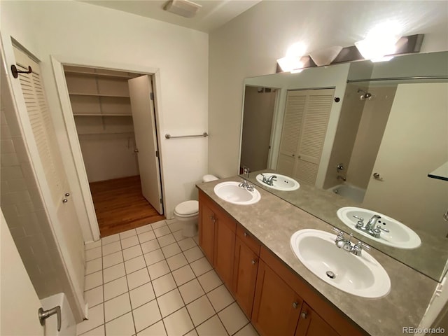 full bathroom featuring tile patterned flooring, vanity, shower / bath combination, and toilet