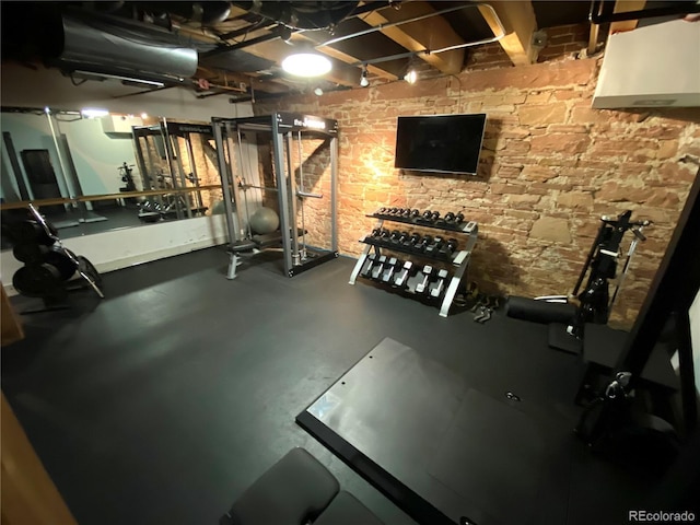 exercise room with brick wall