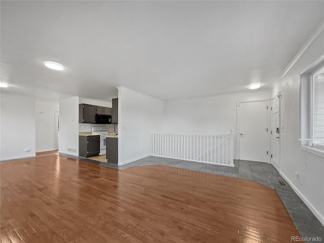 3913 Roosevelt Ave, Wellington, CO 80549 - unfurnished living room featuring dark wood-type flooring