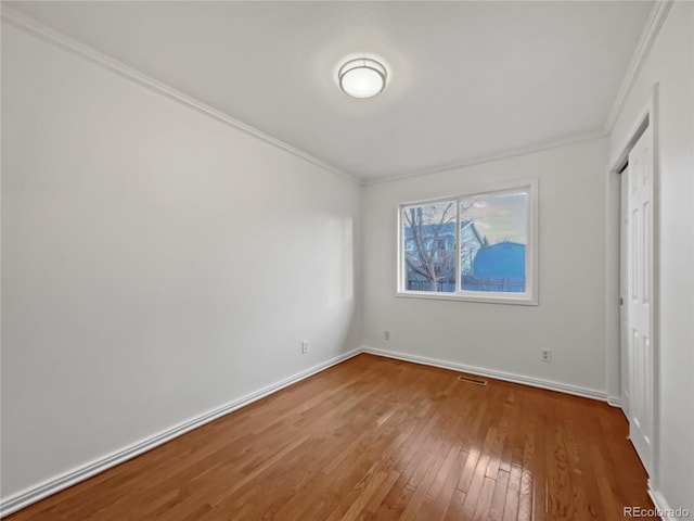 3913 Roosevelt Ave, Wellington, CO 80549 - unfurnished bedroom featuring ornamental molding and wood-type flooring