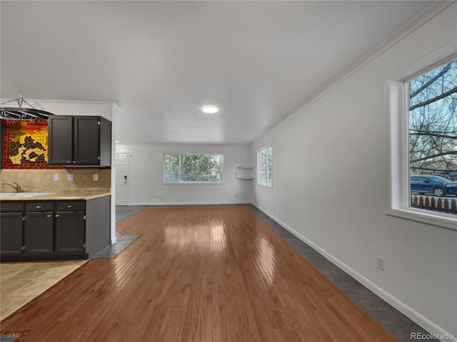3913 Roosevelt Ave, Wellington, CO 80549 - unfurnished living room featuring sink, crown molding, and light hardwood / wood-style floors