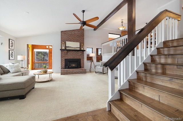 living room with a brick fireplace, high vaulted ceiling, hardwood / wood-style floors, and ceiling fan